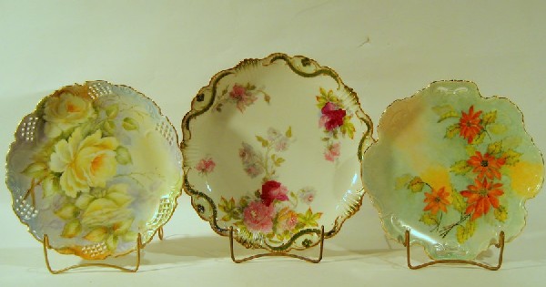 Three Antique Hand Painted Porcelain Platters: Three antique hand painted porcelain platters decorated with flowers including: two signed platters, both 10.25" diameter and one Limoges platter, 11.5" diameter.