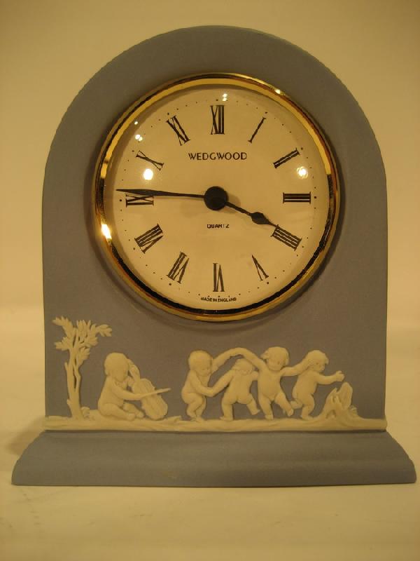 Wedgwood England blue Jasperware dresser clock: Wedgwood England blue Jasperware dresser clock decorated with young children, 4-5/8" high, 4-1/8" wide - in working order.