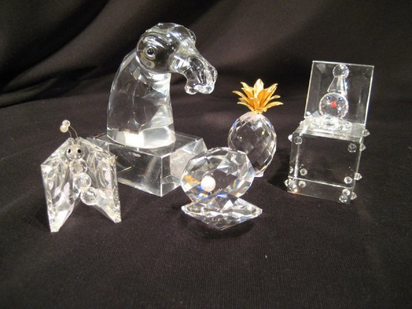 Five small crystal items: Five small crystal items: bust of horse - missing mane, pineapple, jack-in-the-box, book worm - repaired and oyster with pearl - ranging from 1.75" to 4.25" high.