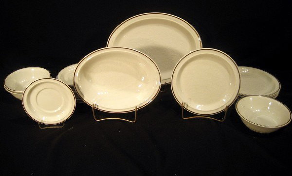 24 Pcs Royal Doulton "Ting" pattern: Royal Doulton porcelain,"Ting" pattern, dinnerware: 5 salad plates, 3 cereal bowls, oval vegetable bowl, 2 mugs - both chipped at rim, 12 saucers and creamer - 24 total pieces.