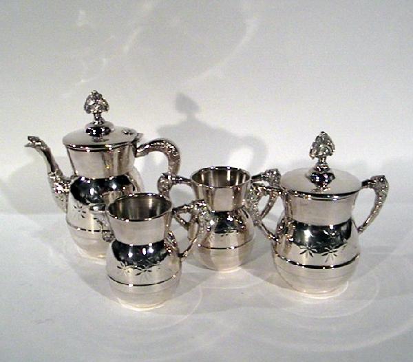 Tea Set: Silver Plated and Decorated with Flowers and L: Tea Set: Silver Plated and Decorated with Flowers and Leaves included are: Teapot, Lidded Sugar, Creamer and a Two Handled Mug- Antique