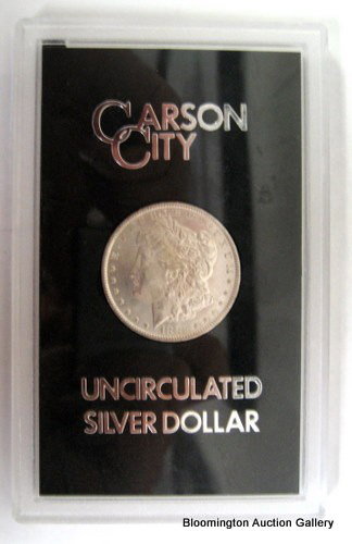 UnCirculated 1882 Carson City Morgan Dollar: Uncirculated 1882 Carson City Morgan Dollar in Plastic card. ***PLEASE NOTE, EXPRESS SHIPPING AVAILABLE FOR THIS ITEM: For an additional handling fee of $15.00, this item will be shipped within 48 bus