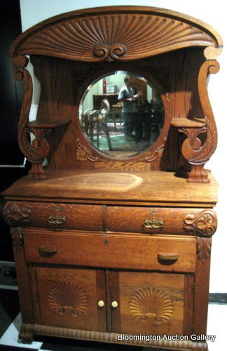 Antique Oak Side Board w/ mirrored back panel: Oak Sideboard with upper mirrored back panel with 2 candle shelves, 2 half drawers, one full drawer, and a lower cupboard decorated with leaves and scrolls - antique - 74"h x 46"w *PLEASE NOTE: FREE S