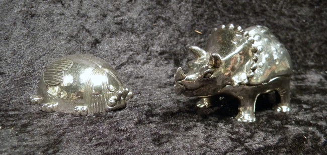 2 Reed & Barton Silver Plate Music Boxes: Two Reed & Barton Figural Music Boxes: "Triceratops" playing "Born Free" , 2.25" high and "Ladybug" playing "You Are My Sunshine", 1.25" high - with original boxes