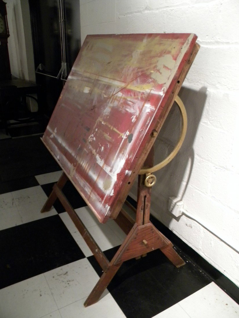Antique Drafting Table w/Brass Adjusters: Antique drafting table with brass adjusters on legs and top, 58" high, 48" wide. Top needs to be refinished. ***Shipping Arrangements: DUE TO THE LARGE NATURE OF THIS ITEM, IT IS THE BUYER'S RESPONSIB