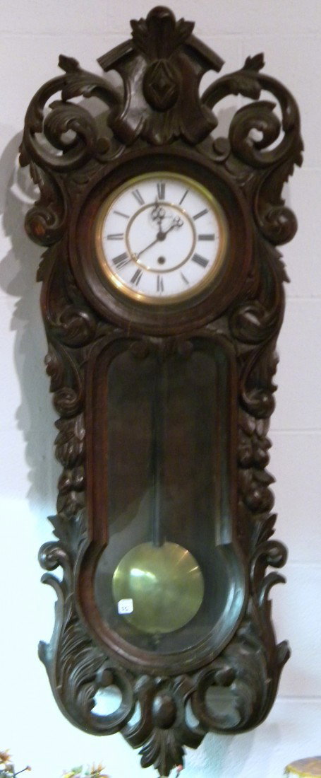 Walnut Cased Vienna Regulator Clock dec w/Scrolls & Lea: Walnut cased Vienna Regulator clock decorated with scrolls and leaves with pendulum, 44.5" high, 16" wide - no weight.
