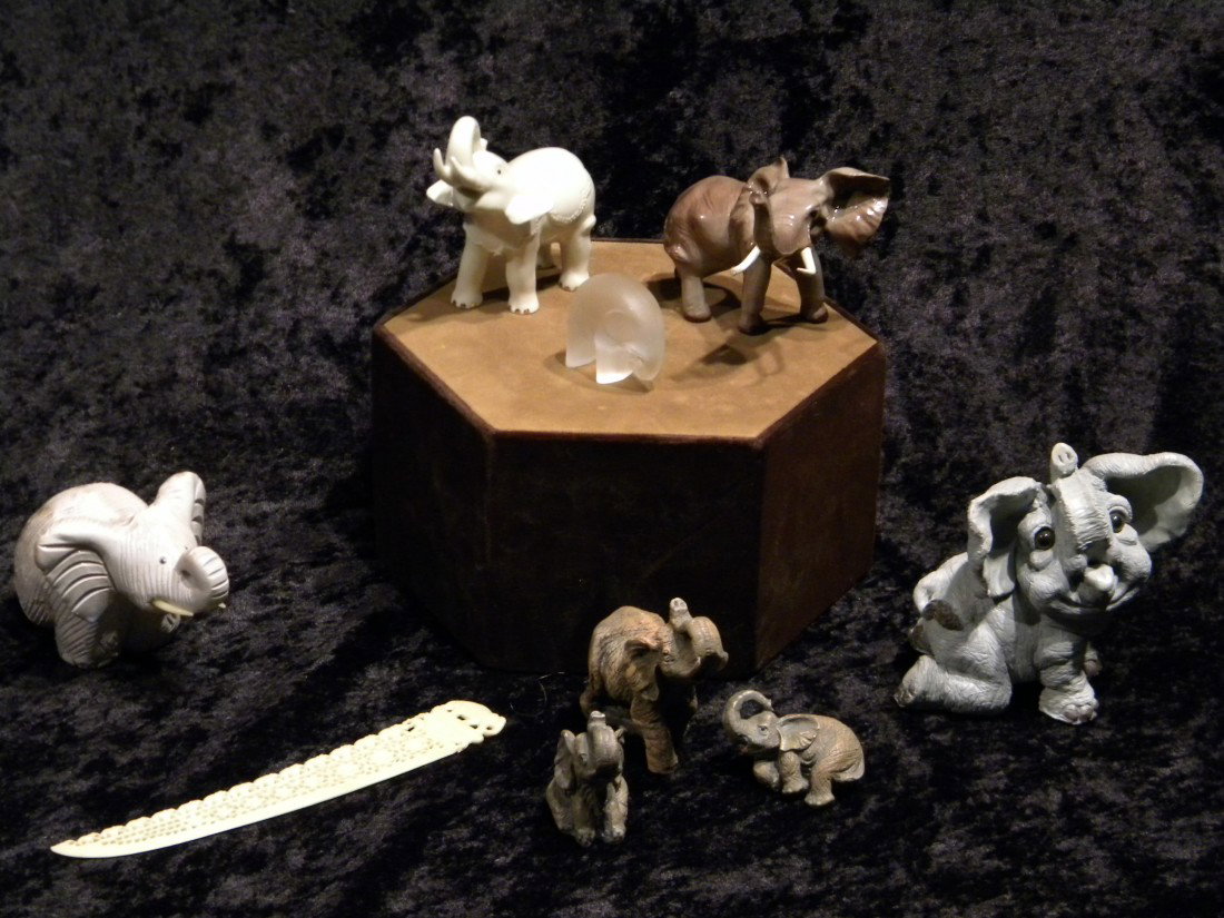 8 Miscellaneous Elephant Figurines: 8 Miscellaneous elephant figurines (1 porcelain marked Lenox) and composition tusk shaped letter opener decorated with elephants.