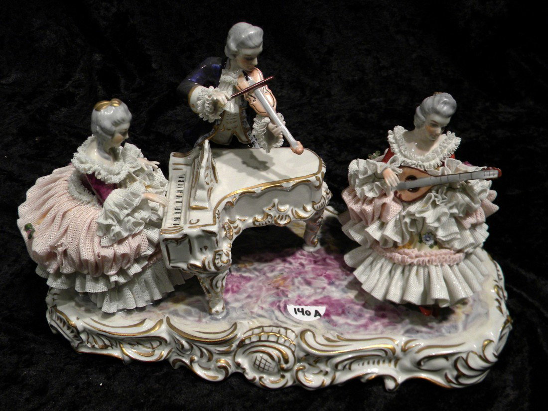 Glazed Porcelain Dresden Style Figural Group: Glazed porcelain Dresden style figural group: lady seated at piano, standing gentleman with violin, seated lady with lute, gilded trim, marked on base in blue under glaze (Crown) MZ, 7.5" high, 13" ac