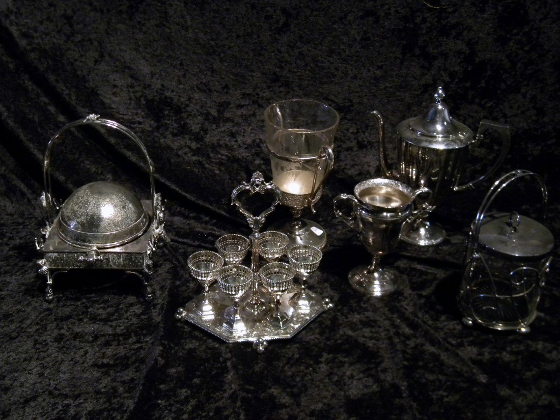 Collection of Silver Plated Items: Collection of silver plated items: egg cup set on stand, master butter, spooner with glass insert, two-handled goblet and lidded glass jar - Vintage