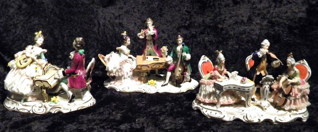 Three Dresden style glazed porcelain musical groups: Three Dresden style glazed porcelain figural musical groups: seated lady at piano, seated lady with cello and standing man with violin, (cello handle broken, some damage to lace), marked in blue Dresd