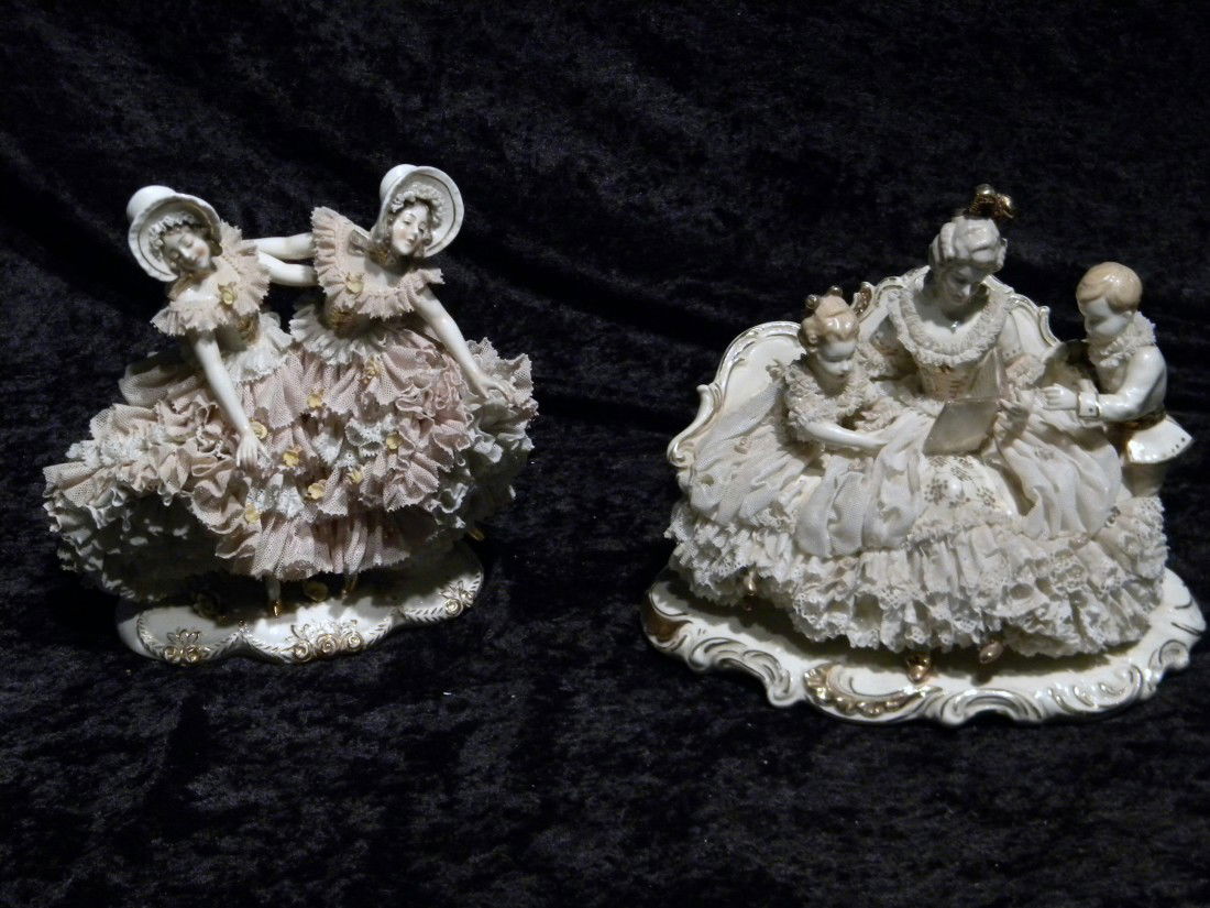 Two Dresden style glazed porcelain figural groups: Two Dresden style glazed porcelain figural groups: lady in white dress on settee reading to children, (damage to lace on dress), marked in blue Dresden Art made in Germany, 7.5" high, 9" wide and two