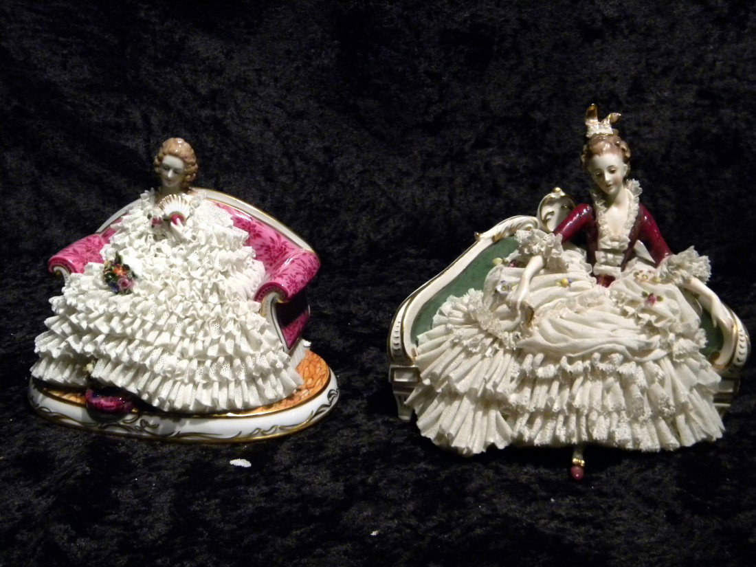 Two Dresden style glazed porcelain figural groups: lady: Two Dresden style glazed porcelain figural groups: lady in white dress holding fan seated on pink settee, marked in blue (Crown) MZ, 5.5" high, 7" wide and lady in white & burgundy dress holding fan s