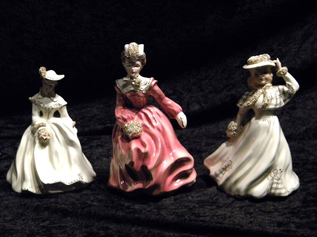 3 Florence Ceramics Ca: Sue, Edith & unmarked: 3 Florence Ceramics, California glazed figures: lady in white dress with hand on hat, 6.25" high; lady in white dress holding flowers "Sue", 6" high and lady in pink dress with purse "Edith", 7.25" hi
