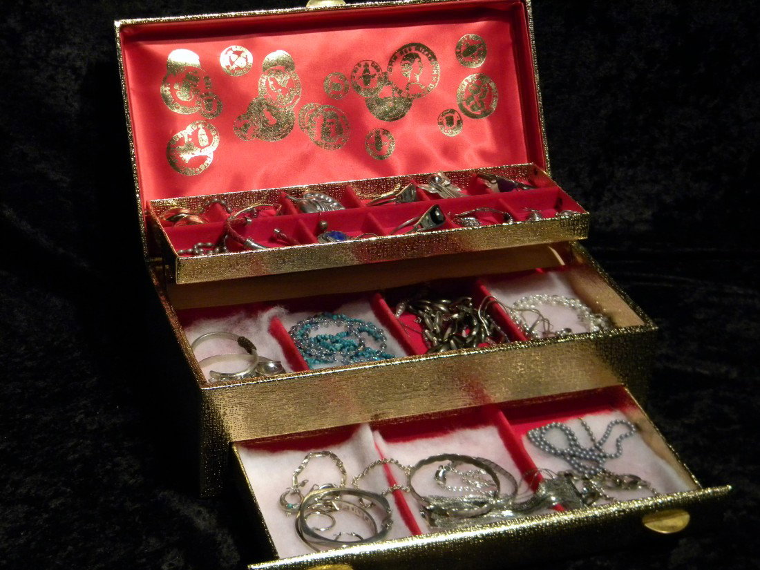 Lot of Costume Jewelry in 3 Tiered Box: Lot of costume jewelry including 14 pieces marked sterling and "925" (143 grams total weight) and 33 pieces unmarked (495 grams total weight), in 3-tiered gold colored jewelry box.