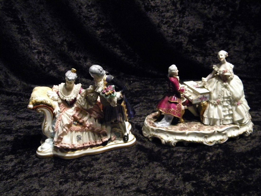 2 Dresden Style Glazed Porcelain Figural Groups: 2 Dresden style glazed porcelain figural groups: seated man playing piano, woman seated on top of piano, marked in red illeg. #706, 6.5" high, 9" wide and seated woman on fainting couch and standing m