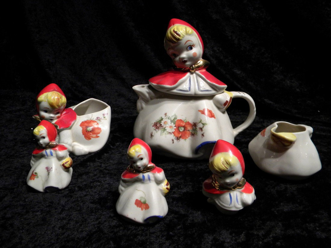 5 Porcelain Little Red Riding Hood Items: 5 Porcelain Little Red Riding Hood Items: lidded teapot with applied handle and spout, floral decal, unmarked, 8.5" high, 8" wide; pair of small salt and pepper shakers with floral decals, unmarked, 3