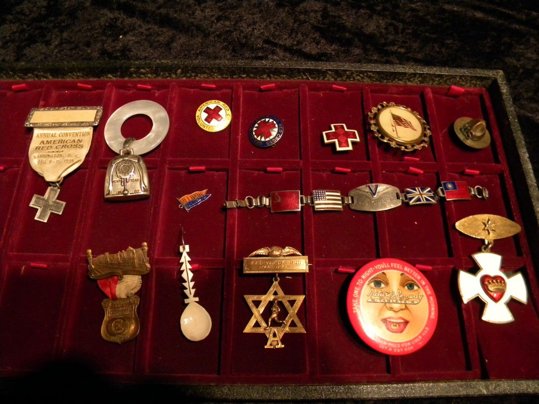11 Miscellaneous Small Items: 11 Miscellaneous small items: 9 pins including 2 round American Red Cross volunteer pins, figural U.S. Marine hat, American flag pin, etc. - sterling silver figural bell pendant and sterling silver li