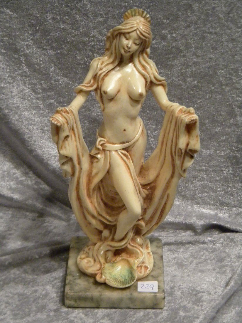 Nude Female Statue "Venus of Capri" on Grey Marble Base: Nude female statue with cloth draped over her extended arms and shells at her feet, on grey marble base, marked The Shapes of Spirit and "Venus of Capri" on base, 12.5" high overall