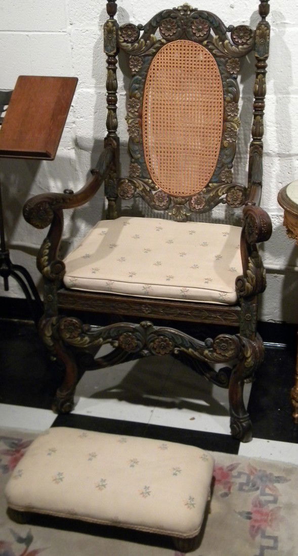Heavily Carved Arm/Throne Chair: Karpen Furniture Co. Heavily Carved Arm/Throne Chair w/caned back and upholstered seat decorated with carved flowers and acanthus leaves with trestle base - 50"H and Matching Foot stool - 4" high, 20"
