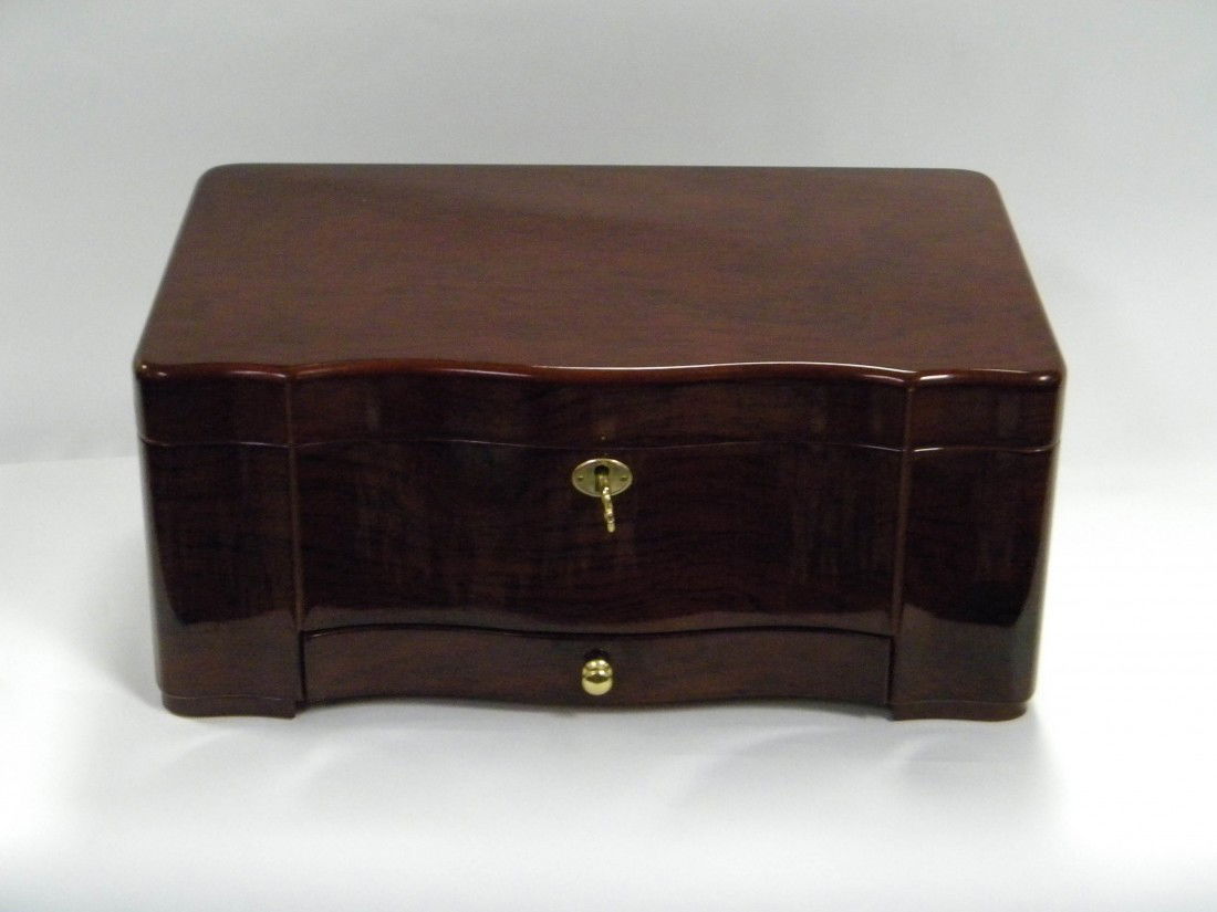 Supreme Humidor by Int'l Development Co.: Supreme Humidor by International Development Company with cherry finish, hinged lid, bottom drawer, brass hardware, and analog aggrometer, Serpentine styled front - 15"w x 6 1/2"h x 9 1/2"d