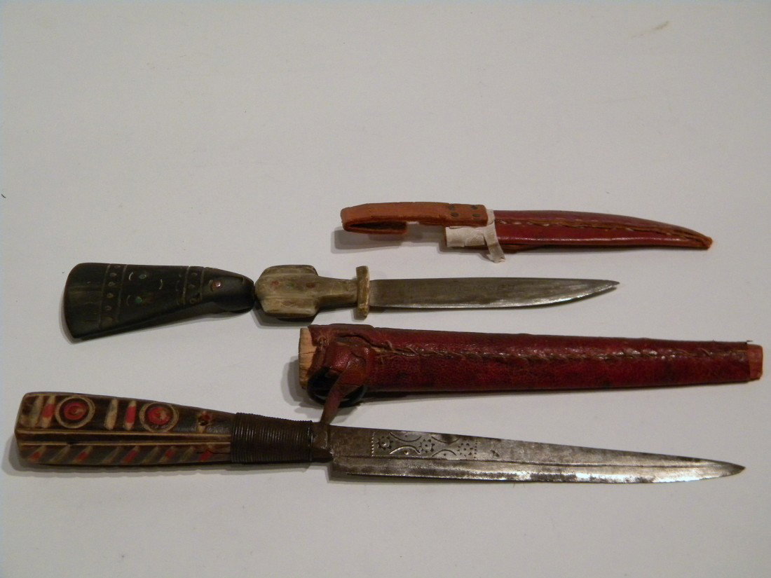 2 Knives: Mayan Indian & South American: 2 knives: Mayan Indian knife in sheath, incised on blade "Chichicastenango" (Guatemala). Handle made from bone and ebonized wood in shape of man wearing headdress, 8.25" long overall and Primitive Sou
