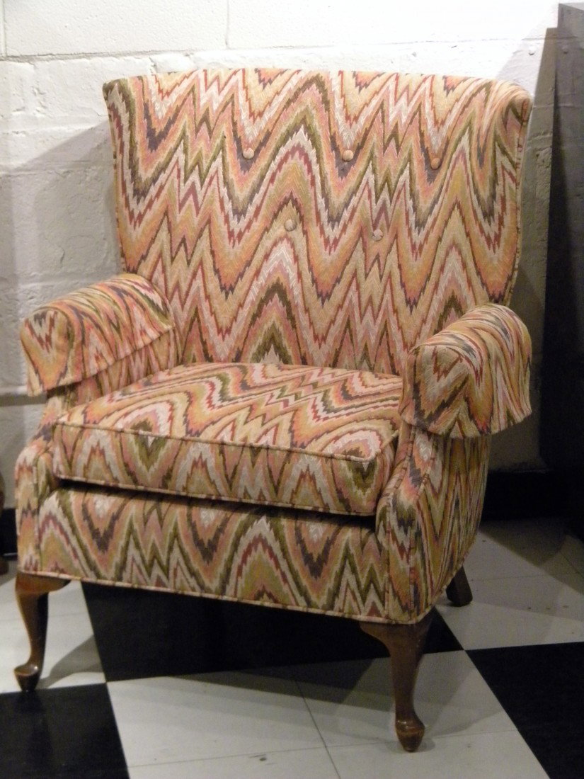 Upholstered Arm Chair w/Cabriole Legs: Multi colored upholstered armchair with short cabriole legs