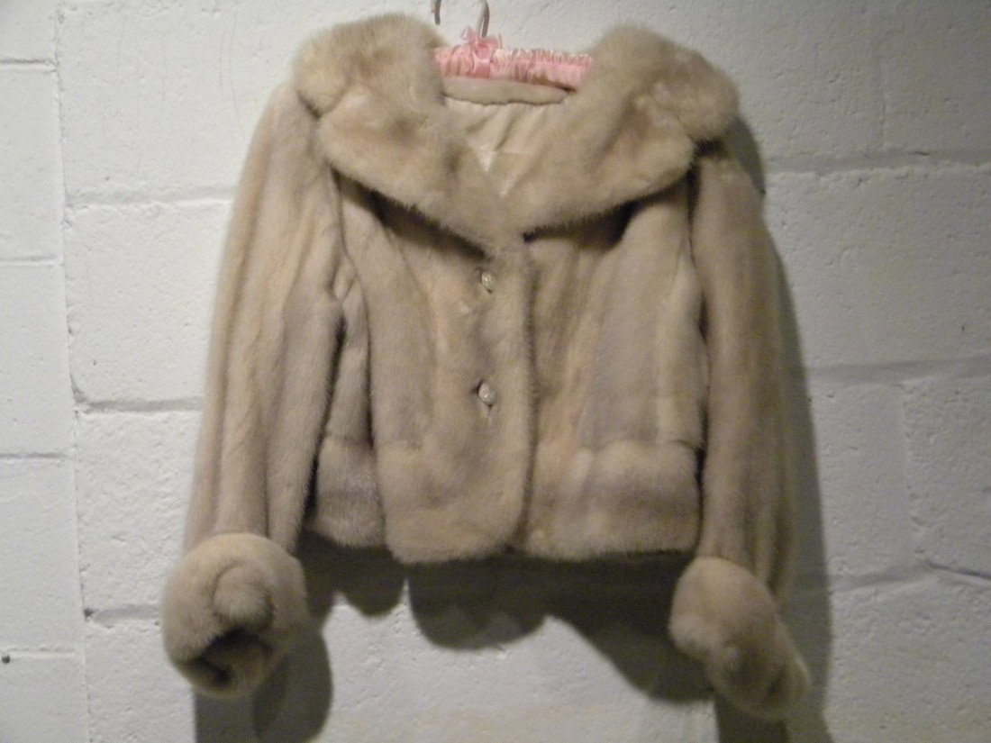 Cream "Petticoat" Style Mink Fur Jacket: Cream "petticoat" style fur jacket with rhinestone studded button closures and wide fur lapels. No size stated but appears to be medium - Tag embroidered Blum's-Vogue, Chicago. Slight tear in lining
