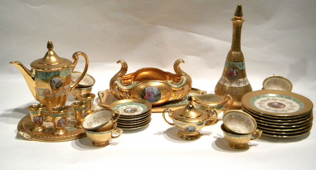 34 Pcs Gilded Le Mieux China, "LEM1" pattern: 34 Pcs Le Mieux China porcelain dinner service, "LEM1" pattern, hand decorated with 24Kt gold and 1700s portrait scenes: 7 scalloped luncheon plates, 1 luncheon plates (not scalloped), 8 footed cups, 