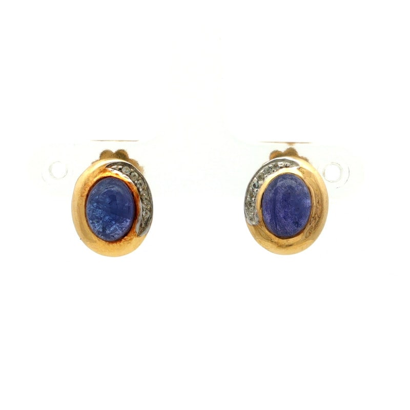 Tanzanite CAB Oval 925 Sterling Silver Rhodium Earrings: Elegant pair of earrings crafted in 925 sterling silver, featuring Tanzanite CAB Oval, 8x6mm, 2 pcs; White Topaz Round, 1.00mm, 12 pcs. Finished with rhodium for a bright, polished appearance. Fitted 
