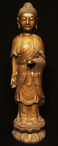 BRONZE BUDDHIST 19 century: finely mondelled standing on a lotus pedestal base,his right hand holding a lotus earing a loose-fiting robe tied at the waist and open at chest,his face with almost-shaped eye beneath high arched bro
