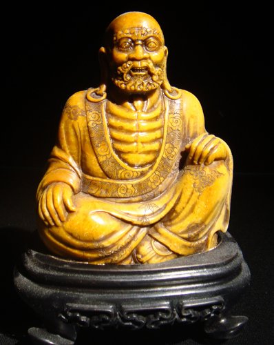 A YELLOW SOAPSTONE FIGURE OF A LUOHAN19TH CENTURY: A WHITE SOAPSTONE FIGURE OF A LUOHAN 19TH CENTURY 3 3/4'' H