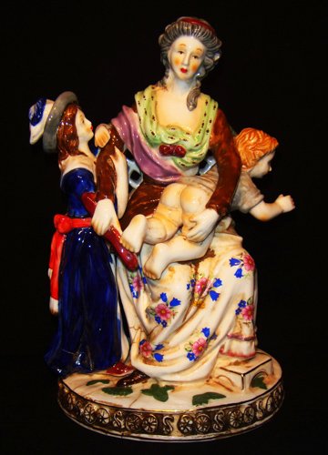A Meissen Porcelain figural modeled: a monther take care of a baby with a girl .Crossd sword mark in blue under glaze, incised ''J66'' M'' 19 century H.8 1/2''