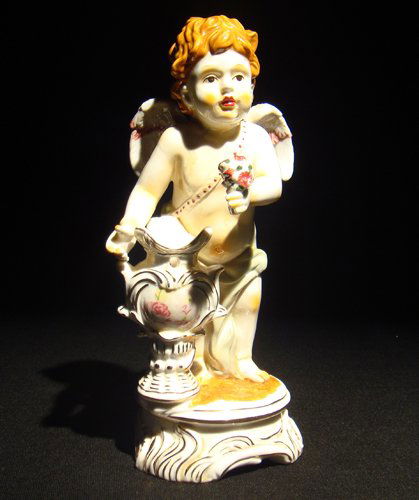 Meissen porcelain cupid figure: ) Meissen porcelain cupid figure; Cross swords mark in blue under glaze, incised, "H610" impressed, "78" 8H ", Circa - Late 19th C.