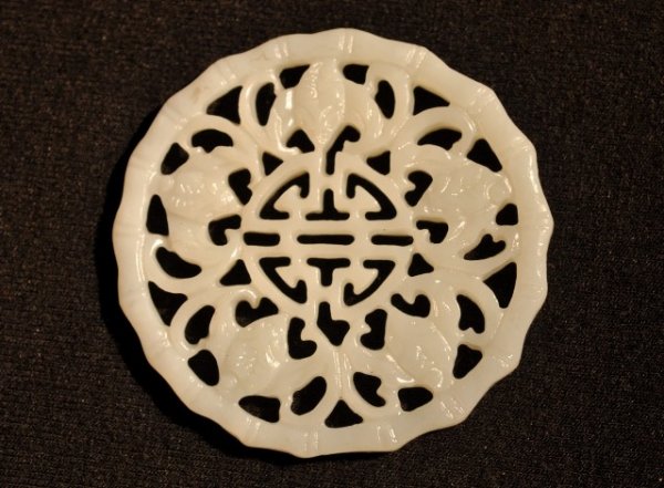 A WHITE JADE PENDANT.(QING DYNASTY).: A WHITE JADE PENDANT FINE CARVING OF FIVE BATS AROUD SHOU NCHARACTER . QING DYNASTY.2'' DIAM.