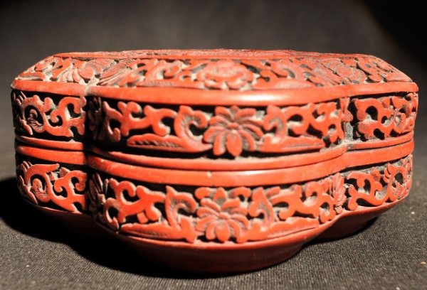 A FINELY CARVED FOUR -LOBED CINNABAR LACQUER BOX A: A FINELY CARVED FOUR -LOBED CINNABAR LACQUER DRAGON BOX AND COVER MING DYNASTY,WANLI PERIODwell carved on the top with a dragon with pearl, the interior and base black.four characters mark. 2 1/2'' H