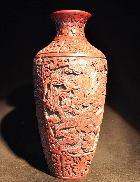 A FINELY CARVED CINNABAR LACQUER CIRCULAR DRAGON V: A FINELY CARVED CINNABAR LACQUER CIRCULAR DRAGON VASE.QING DYNASTY, SIX CHARACTER MARK.12'' H