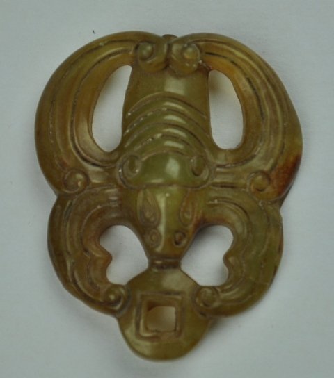 A YELLOW JADE PENDANT. ( HAN DYNASTY): A yellow jade pendant ( HAN DYNASTY) 2 1/8'' X1 3/4''