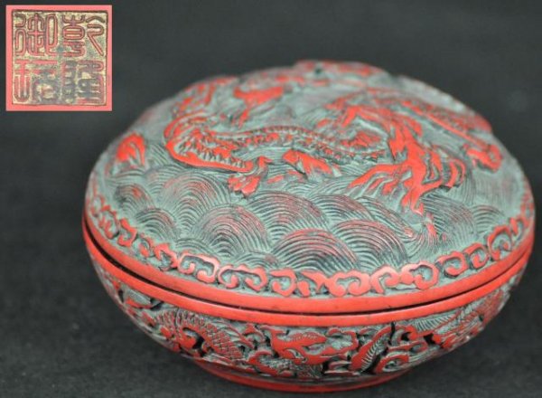 A CINNABAR LACQUER BOX AND COVER.(MARK AND PERIOD: A cinnabar lacquer box and cover carving of a dragon chasing a pearl.(Mark And Period Of Qing Long) 4'' x 2 1/4'' in
