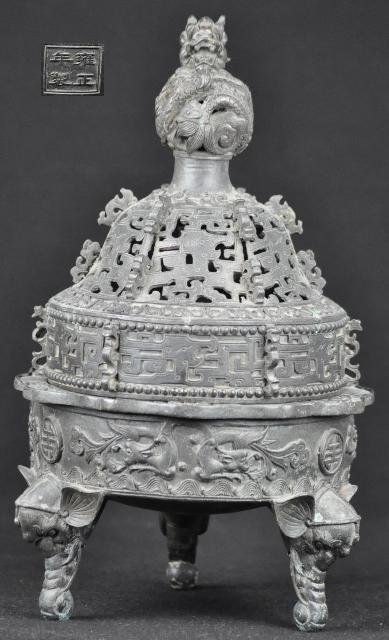A BRONZE INCENSE BURNER.(MARK AND PERIOD OF YONG Z: A bronze incense burner casted with elephants head as the foot of the burner with a dragon head.(MARK AND PERIOD OF YONG ZHENG) 14''in Tall