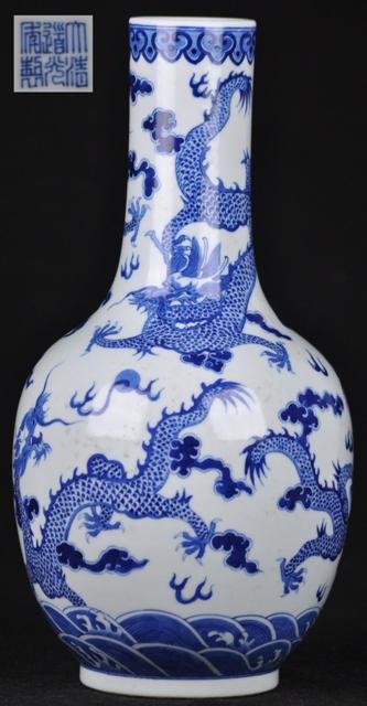 A BLUE AND WHITE DRAGON BOTTLE VASE.(MARK AND PERI: A blue and white dragon bottle vase with a few painting of dragons chasing a pearl.(Mark And Period Of Daoguang) 14''in Tall