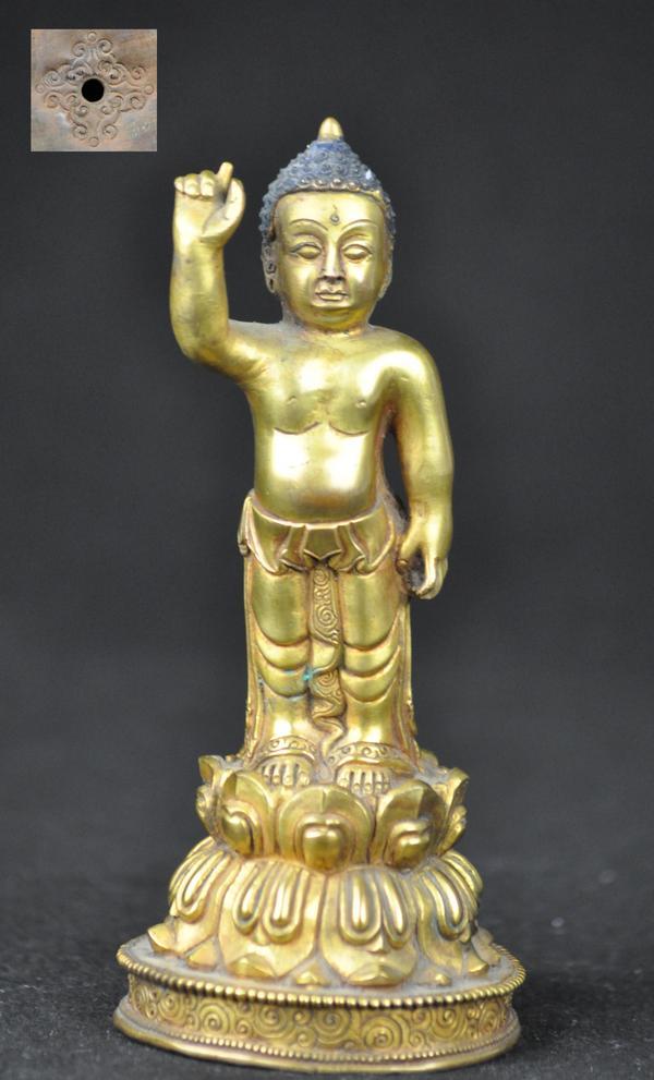 A Gilt Bronze Figure of Buddha Shakyamuni.(18 centur: A Gilt Bronze Figure of Buddha Shakyamuni.(18 century) His right hand is pointing to the sky,and he is standing on a lotus base. 6 3/4''H