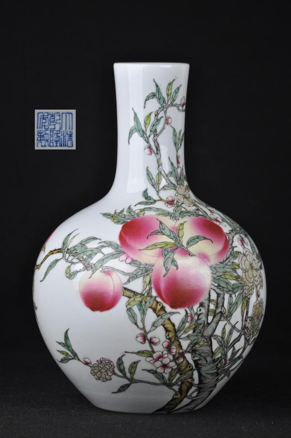 A FAMILLE-ROSE PEACH BOTTLE VASE.(MARK AND PERIOD O: The body is decorated with nine peaches and five bats surround the vase marked on the vase.13 1/2''H
