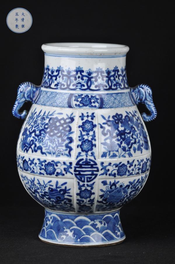 A BLUE AND WHITE TWO -HANDLED VASE.(MARK AND PERIOD: The vase painted bajixiang eight buddhist emblems,divided by lotus heads issuing scrolling leaves.mark and period of yong zheng.13 1/4''H