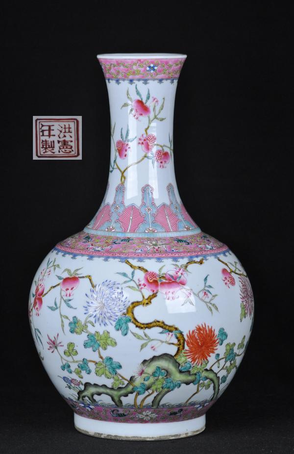 A FAMILLE-ROSE BOTTLE VASE.(MARK AND PERIOD OF HONG: The vase is decorated with florals and fruits and bats four character mark on the base. 16 1/2''H