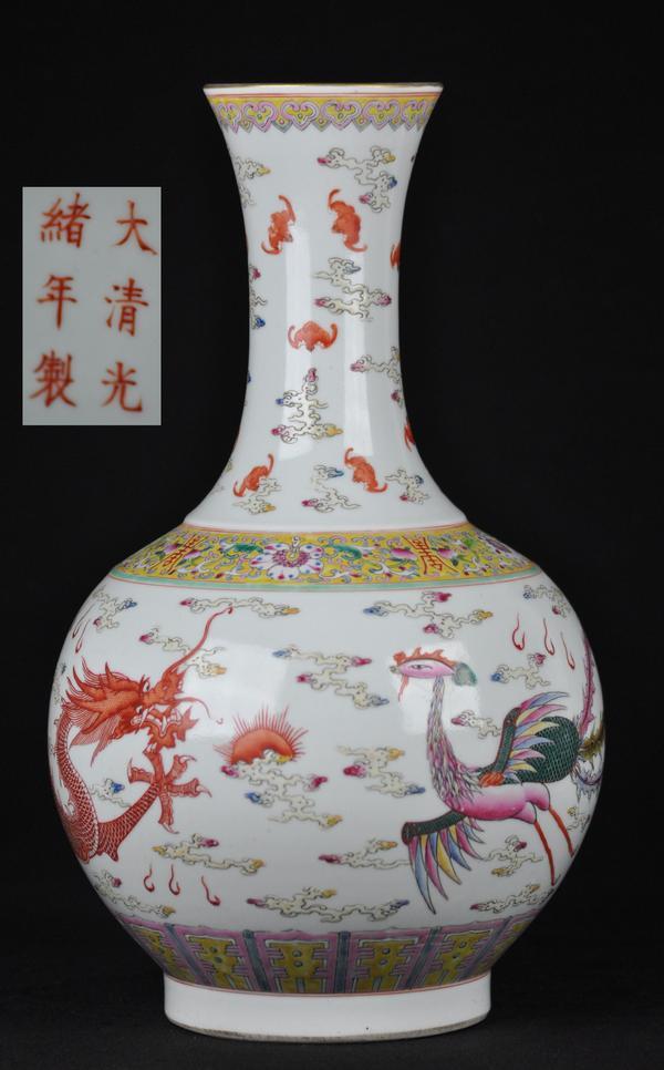 A FAMILLE-ROSE BOTTLE VASE.(MARK AND PERIOD OF GUAN: The vase is decorated with a dragon and a phoenix and bats six character marks on the base. 16 1/2''Tall
