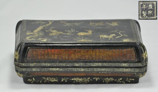 BLACK CINNABAR LAQUER.(MARK AND PERIOD OF KANGXI): The cover painted with deer and crane on the mountain four character marks on the base. 3-1/2''x 9-1/2'' x 6-1/2''