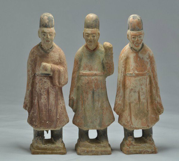GROUP OF THREE POTTERY FIGURES OF OFFICERS. (HAN): A group of three painted pottery figure officers.7''Tall. (Han Dynasty.)