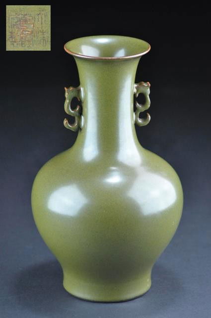 A TEADUST-GLAZED BOTTLE VASE .( MARK AND PERIOD OF: With broad body and neck, covered all over with a finely mottled opaque glaze of pale and darker olive tone thinning to the clear glaze on the rim and ending in a neat line on the foot, the base simil