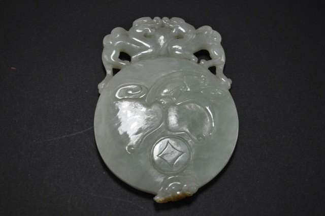 A WHITE JADE PLAQUE.: One side carved with bat reversed carved a gold fish and tow dragons on top of it.4 ''x 3 1/4''