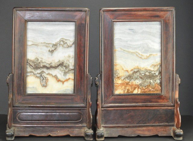 A PAIR OF DALI MARBLE AND WOOD TABLE SCREENS.( QIN: The attractive variegated black,white and buff stone set within a wood frame with beaded edges ,raised on base terminating in shoe feet with standing sqandrels joined by a shaped apron. 23''x13 1/4''i